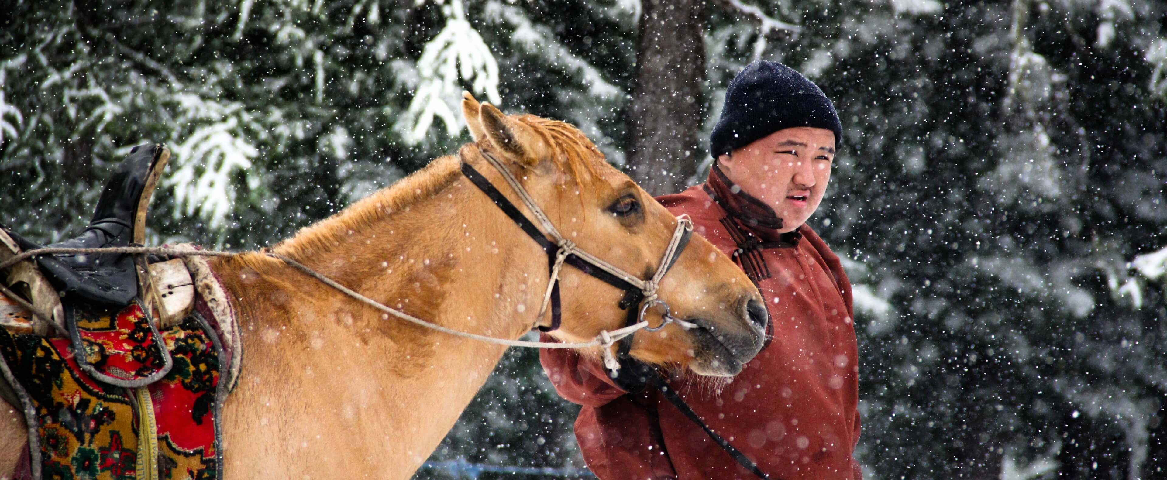 A Mongolian man with a horse